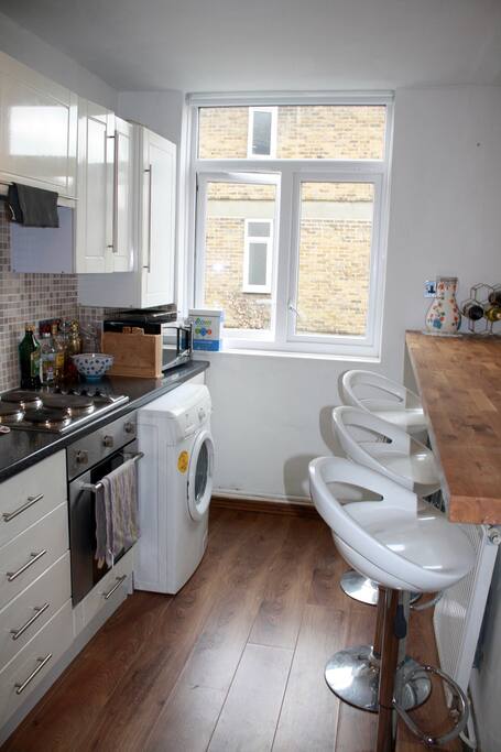 The kitchen is outfitted with all the necessary appliances, including a washing machine, oven, microwave, toaster, Nespresso machine and a state-of-the-art blender