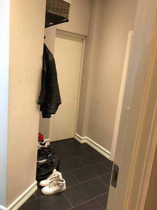 Hallway with entry to storage room, living room and bedroom