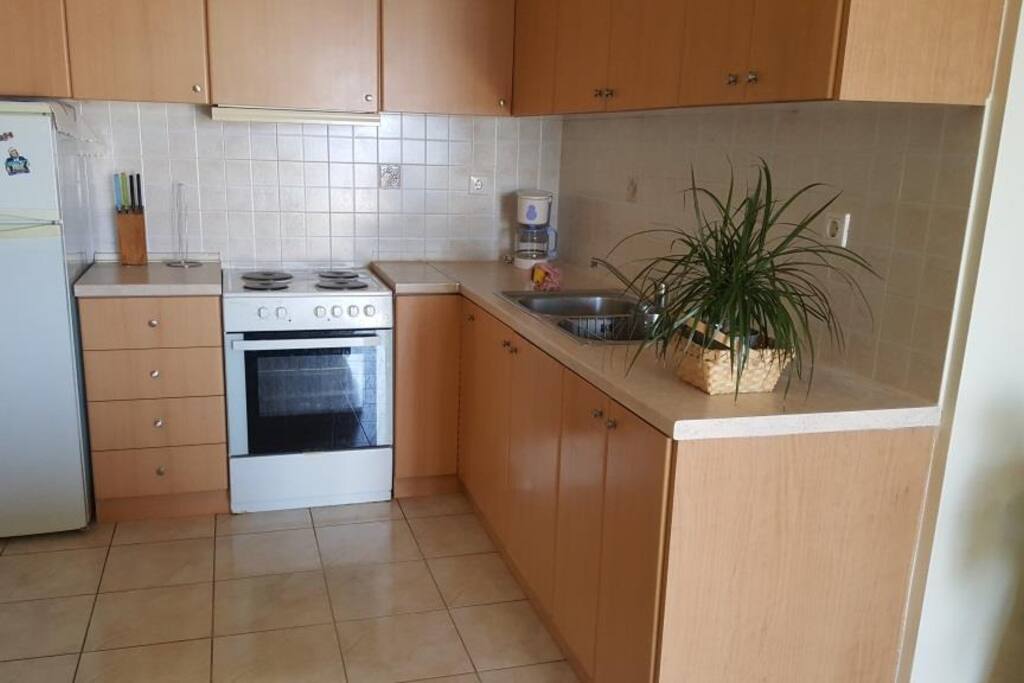 Kitchen with cooker fridge freezer microwave and all cooking utensils.