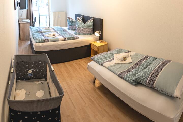 2 people can sleep comfortably 2 people in the king size bed. The fold-out couch offers an additional sleeping space. A crib is always available. 