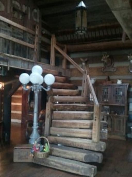 Chestnut log staircase leads up to the Jefferson Island Suite