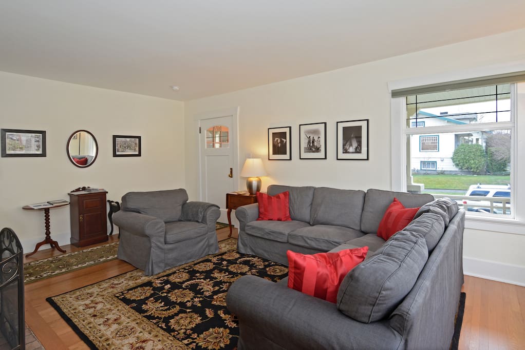 Formal living room with period photos of Seattle and comfortable seating!