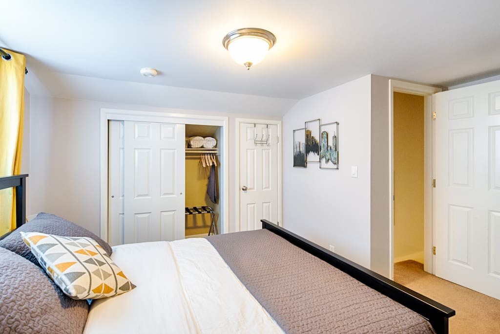 Deep closet will hold your luggage just fine. Bedroom door exits to stairs going down to main level.