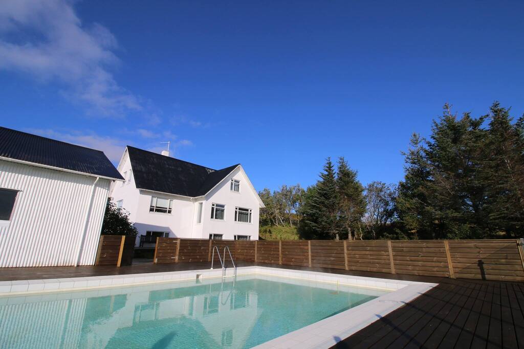 The view from the pool to the farmhouse, you can see one of the other houses too.
