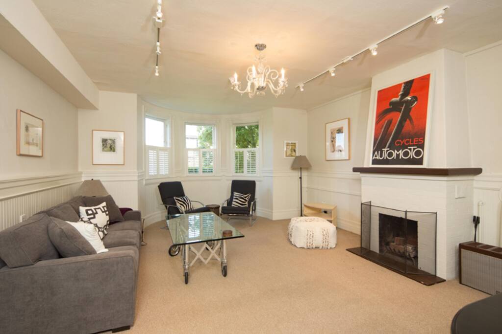 Large living room with bay window, decorative fireplace