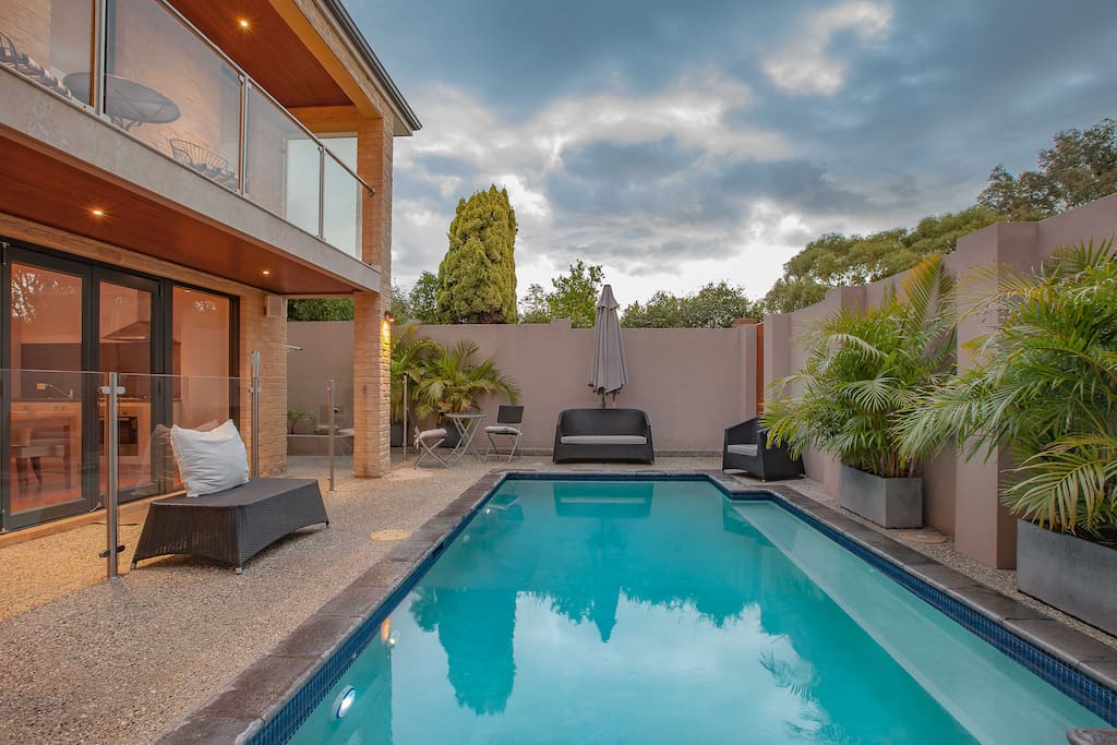 Pool and surrounding lounge area.