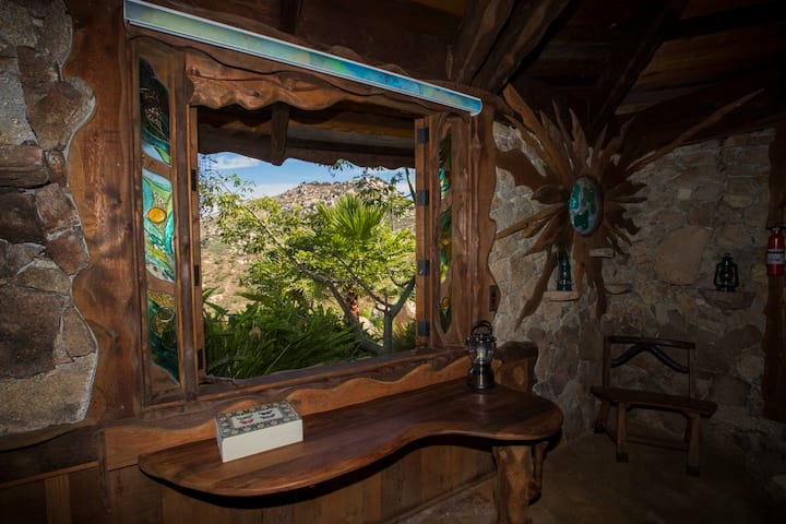 glass windows open up to let in natural light and outside breeze in real-life Hobbit House in California