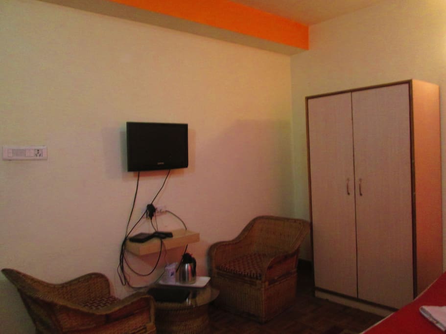 Wardrobe and sitting area with TV