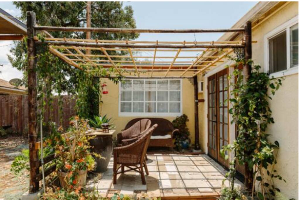 Front door patio with passionfruit vines. Currently the vines are nice a green.