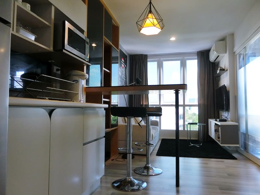 mini bar and 2 stools and microwave oven