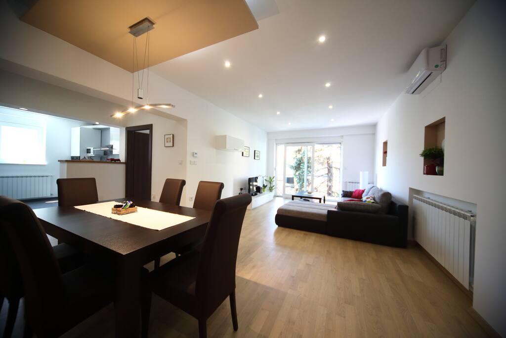 Living area connected to kitchen and with access to balcony.
