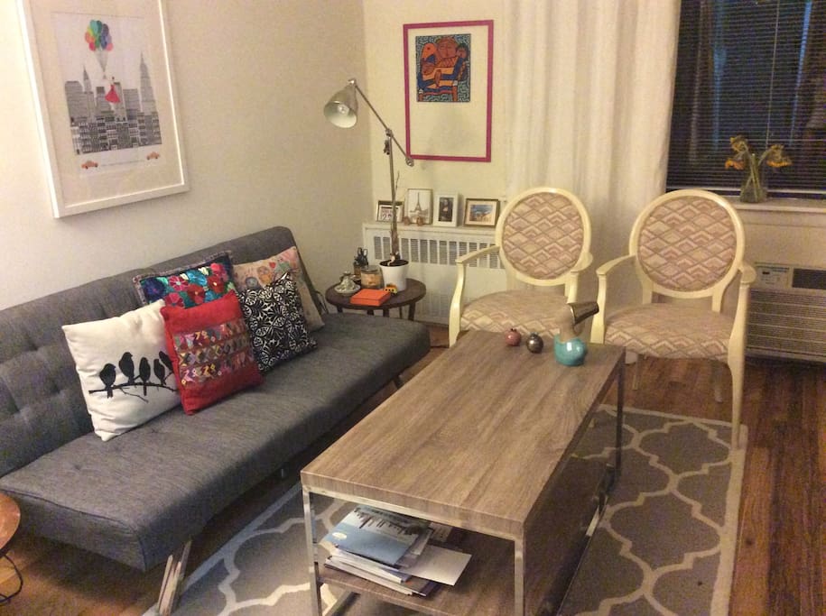 Cozy living room with sofa that can be flattened for extra sleeping bed.