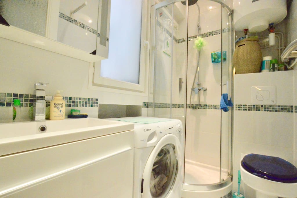 The bathroom with shower and washing machine