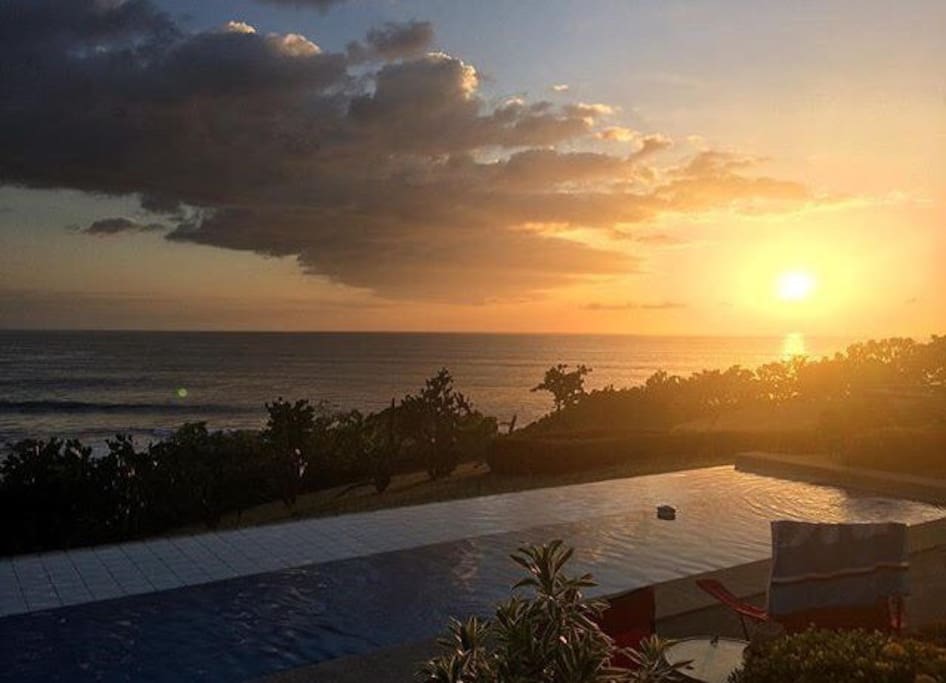 sun setting over the pool and the pacific