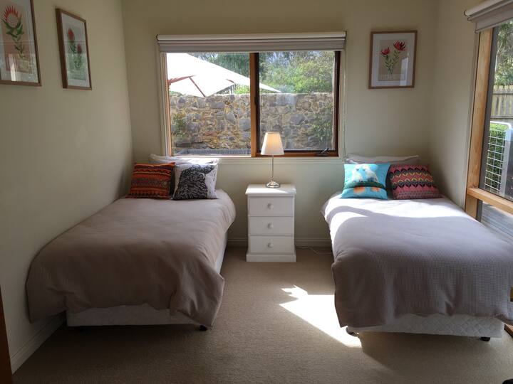 Super comfy King Single beds in front room with storage closet,electric heater and great views.