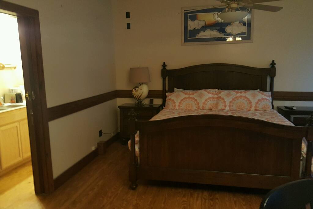 King bed, with sliding glass doors to separate the kitchen.