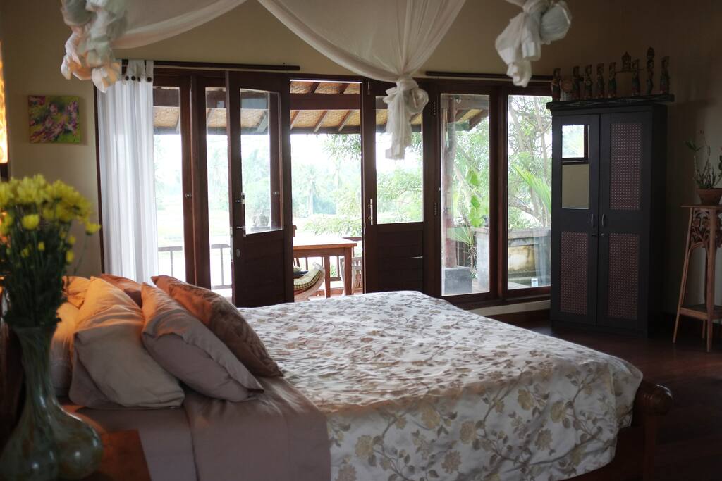 Private balcony with fish pond, breakfast table overlooking rice fields to the horizon