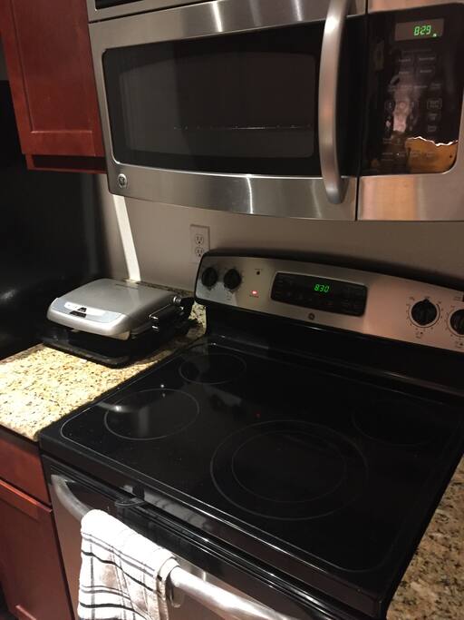 Modern appliances in kitchen including brand new coffee maker.