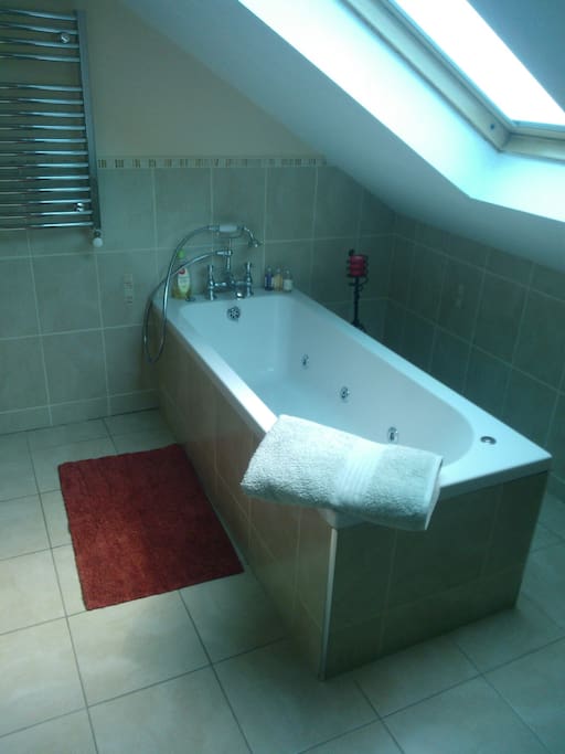 Jacuzzi bath beneath sky light window