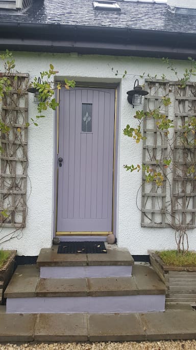 The lilac front door leading to the private double apartment.