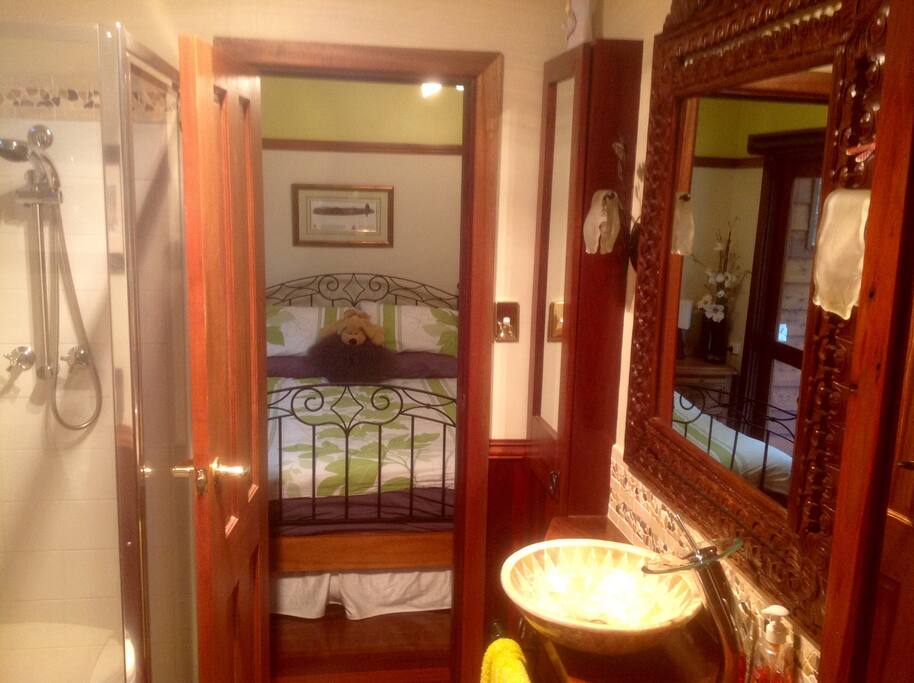 Private ensuite with shower, toilet, basin, hairdryer, heat lamps.