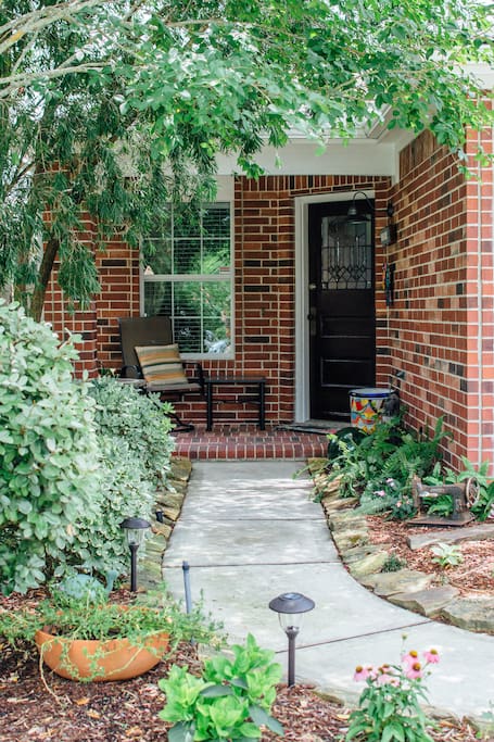 Lovely entry past the fountain to the antique craftsman door.