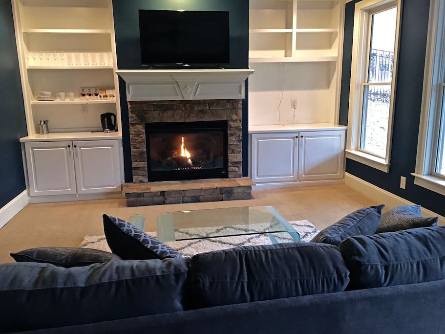 Living room with warm and cozy fireplace.