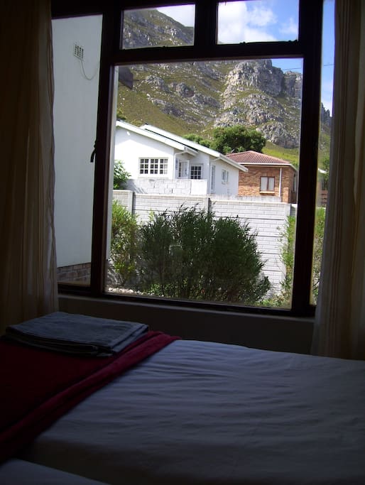 The room has a large window, with a beautiful mountain view of the Fernkloof mountain range. The room is next to a private garden, which is for guests.