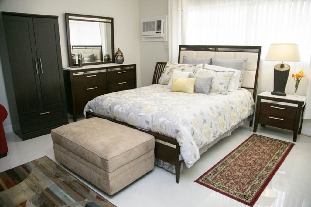 Big suite with queen bed, queen-sized convertible sofa bed, and single roll-away bed (upon request.) Dresser, armoire and ottoman with fresh towels. Free parking. Free WI-FI internet connection. Free cable on TV.