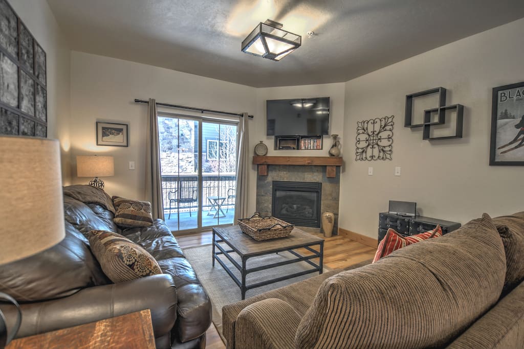 Living Room - Gas Fireplace, sleeper sofa, 49" HD Smart TV, DVD player, Bose Sound Docking Station, balcony access