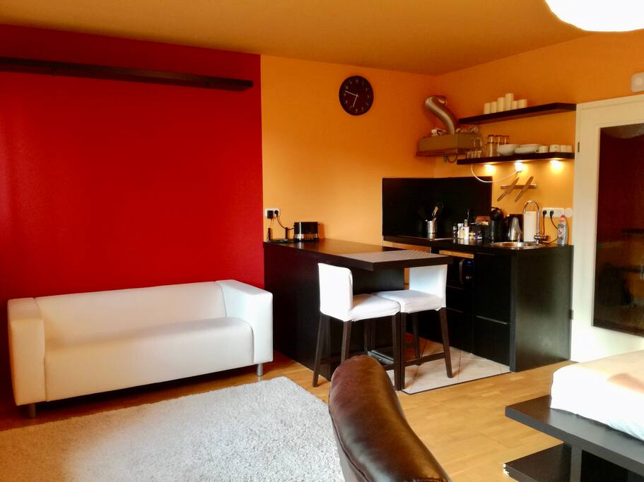 Mail area, kitchen on the right, dining area in the middle, sofa on the left.