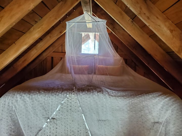 All cotton bedding with mosquito netting in the queen bed loft area.
