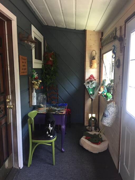 You will enter to our sun porch which is also residence to Corkie our cat. She has free roam to come and go but can be closed out for a time if she gets too friendly. It's a nice place to read and soak up the sunshine!