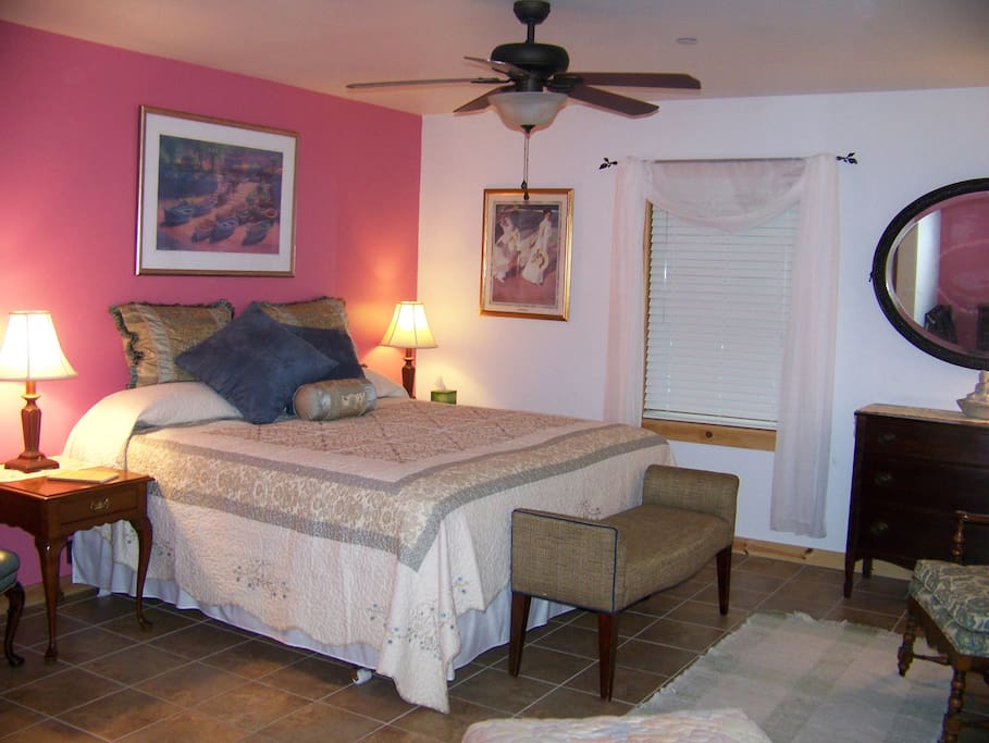 West Bedroom with king size bed, private full bathroom, ceiling fan & climate control.