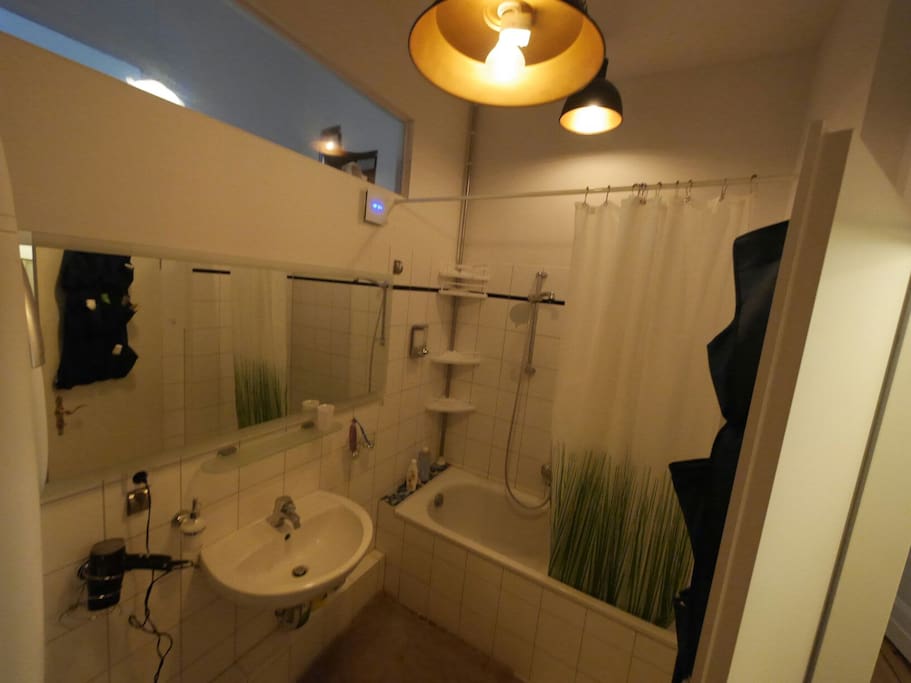 Bathroom Shower with large mirror and rustic carbon filament bulbs.