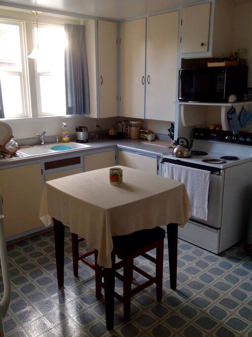 Kitchen with available microwave, range, refrigerator, coffee station, kitchen utensils, etc.