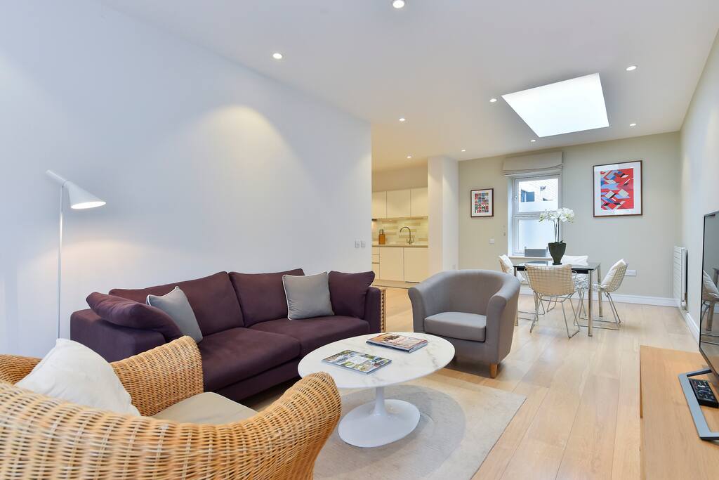 The light, spacious living area boasts a sofa, two armchairs, flat screen TV and a dining table for 4 people.