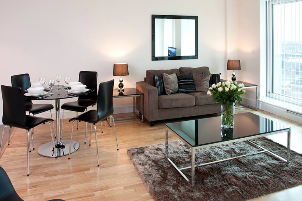 Comfortable Living-room with flat-screen TV and a work/dining table