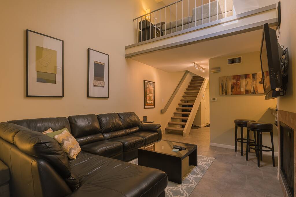 living with view of loft that contains another couch