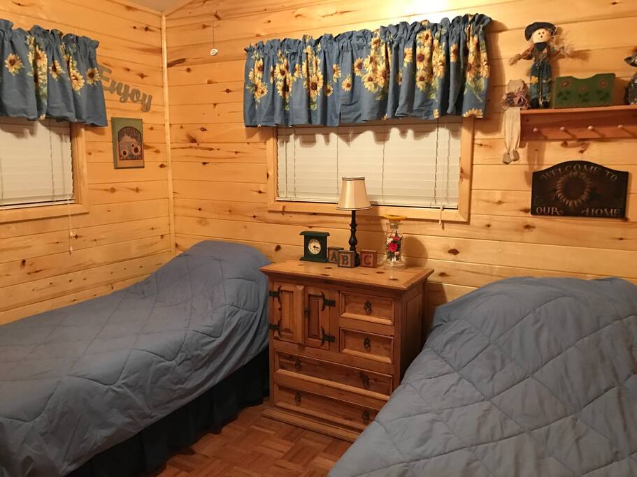 Guest bedroom two twin beds on wheels to easy push together to create a full size bed