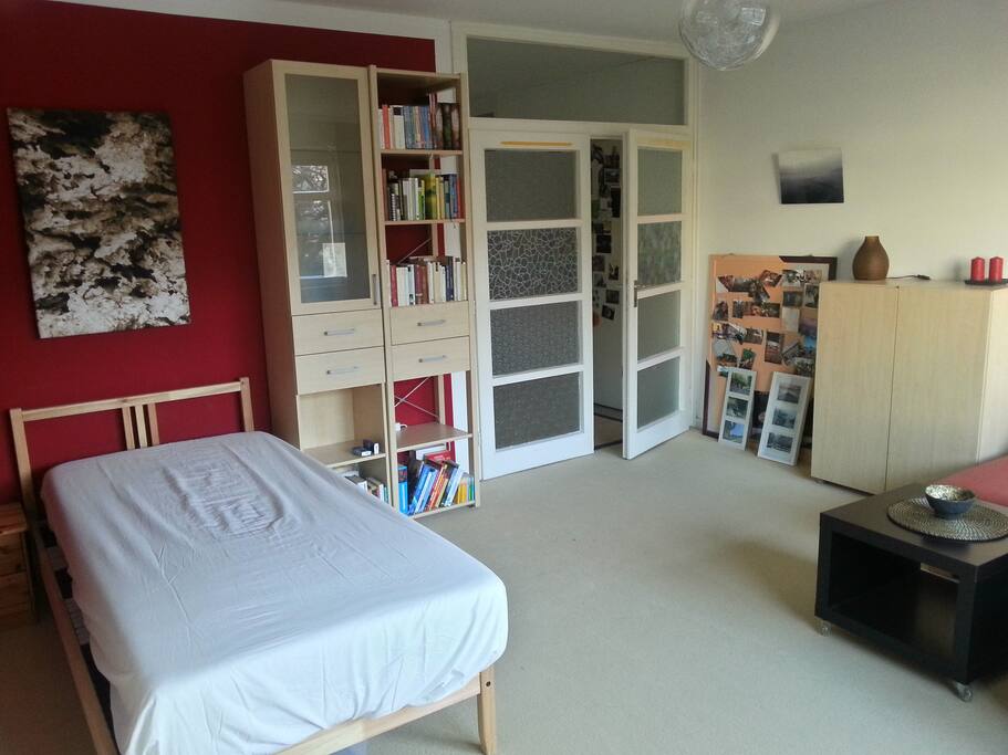 Your bed and the ~24 sqm-room for your stay.