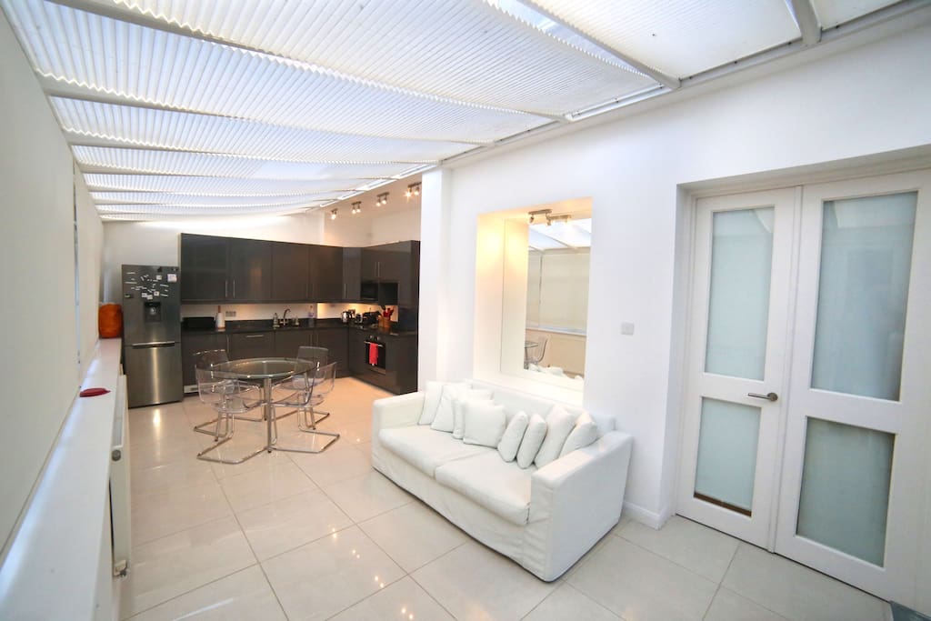 Open plan living area and door to bedroom.