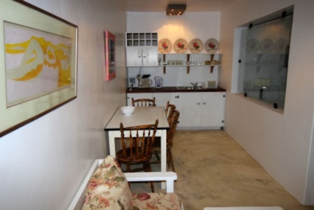 Kitchenette with dining area opening onto court yard.