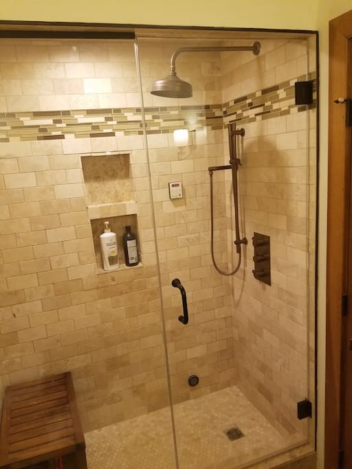 New marble steam bath with rain shower and teak bench