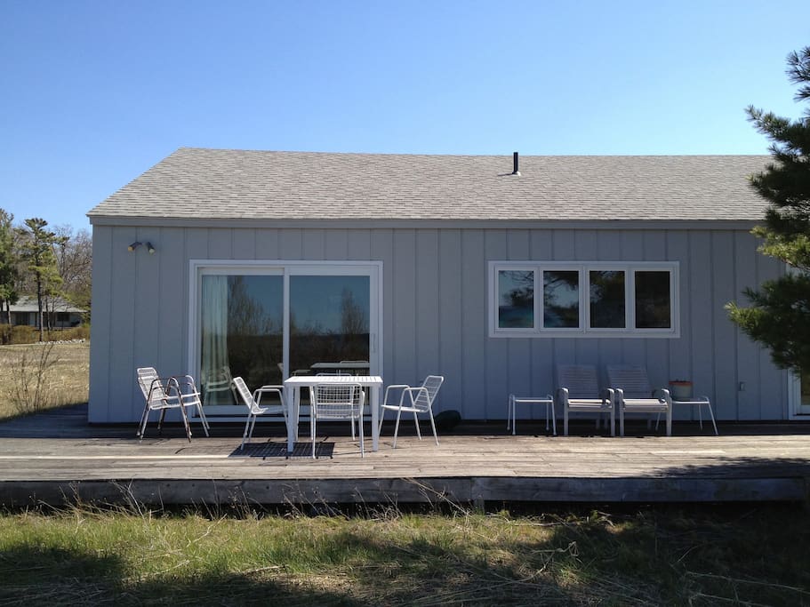 The Beach House is surrounded on all sides by a deck, outdoor shower