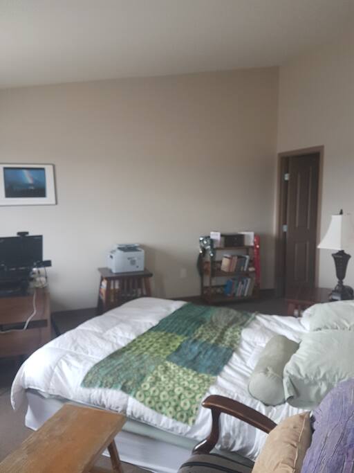 Master bedroom with ensuite to the right. Chair allows you to see the mountains while you have your morning coffee!