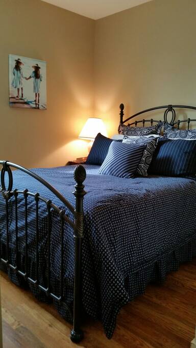Queen size bed with beautiful bedding and quality mattress.