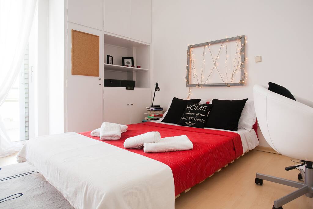 The private room features a double bed, lots of storage space and a desk suitable for laptops