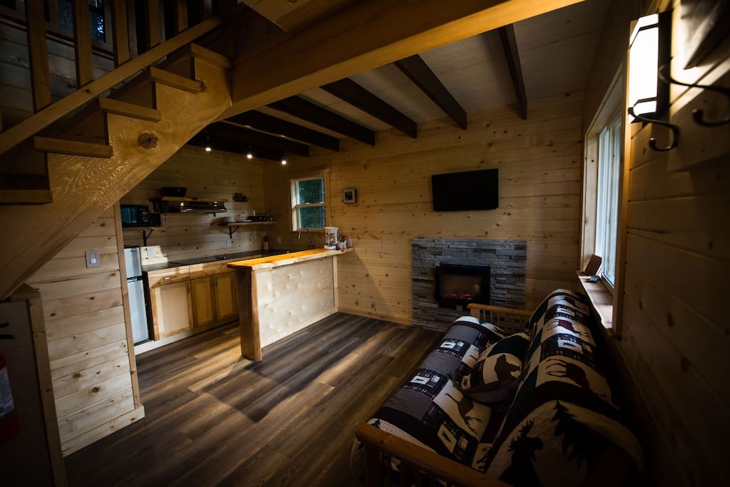 Entryway, kitchenette, futon and fireplace