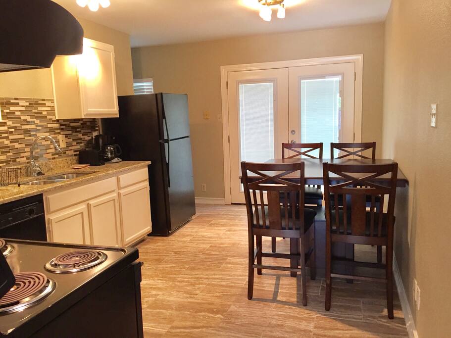 Kitchen with refrigerator, stove, coffee maker. Washer and dryer.